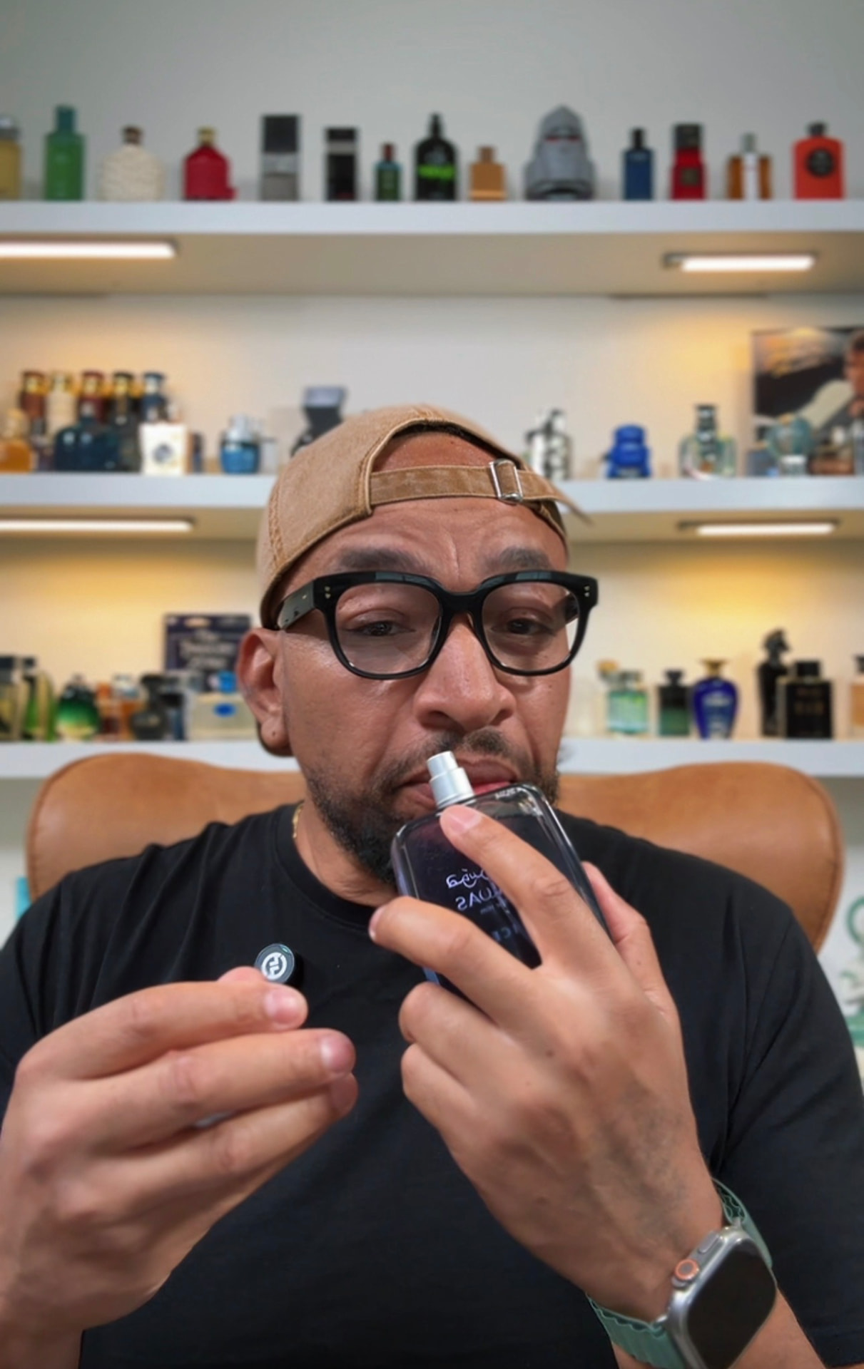 Hobbs, founder of Just Hobbs Index, holding a fragrance bottle